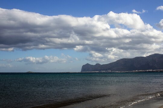 evocative image of marine promontory with coast, sea, sky and clouds in Sicily
