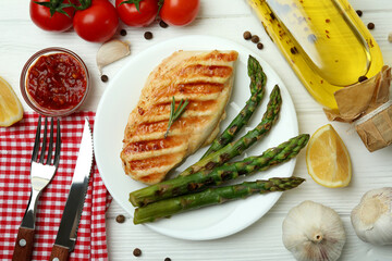 Concept of tasty eating with grilled chicken on white wooden table