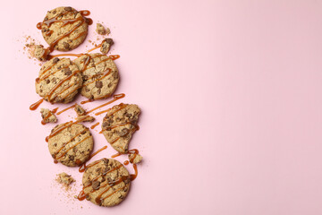 Cookies with caramel on pink background, space for text