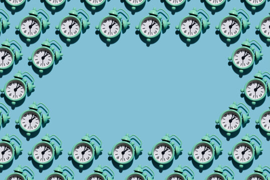 Table clock pattern in modern style with hard shadows, flat lay. Budtbook on a blue background in the form of a pattern. Irregular pattern, space for text.
