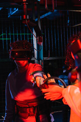 Obraz na płótnie Canvas teenage boy gaming in vr headset near girl on blurred foreground