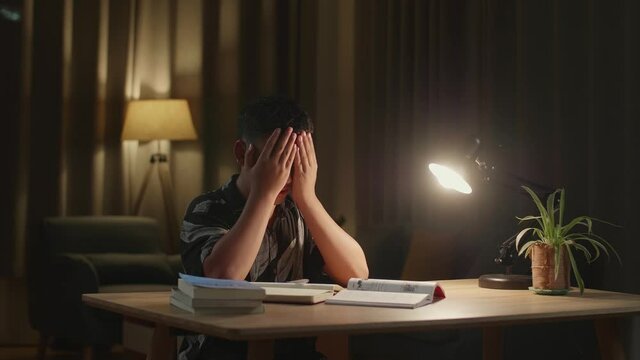 Asia Boy Feel Pain Eyestrain Rubbing Dry Irritated Eyes Fatigued From Doing Home Work
