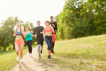 Group of friends jogging in summer