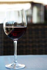 a glass of red wine in a glass at the bar