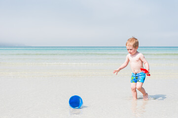 Child boy playing on beach