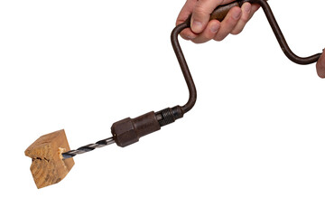Man drilling a hole in a piece of woodwork with antique hand drill (chest lyre) and a clamped new wood bit. Clipping path. Macro. Isolated on white background.