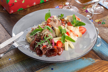 wine antipasti and appetizer cheese, ham and strawberry on wooden table