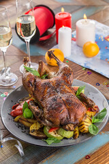 whole roasted Duck with grilled vegetables for Christmas on wooden table