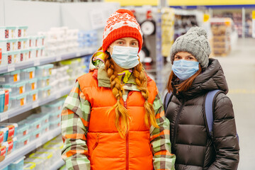 Medical mask. Two women stand in a supermarket wearing a medical mask.