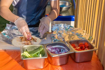 Foto op Canvas A professional chef fills the gyros with stuffing © Alex Images