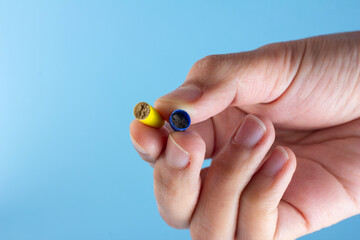 Antibiotic powder in the capsule in hand isolated on a blue background.