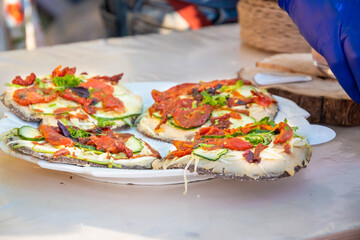 Round pizza made of black dough.