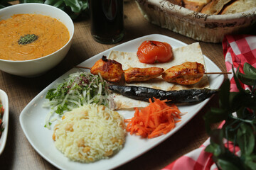 Turkish Adana Kebab with fresh vegetables on flatbread Top view, flat lay