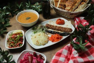 Turkish Adana Kebab with fresh vegetables on flatbread Top view, flat lay