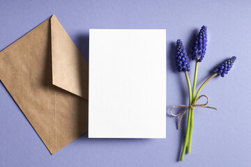 Greeting card stationary mockup with envelope and spring blue muscari flowers