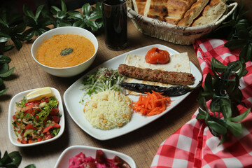 Turkish Adana Kebab with fresh vegetables on flatbread Top view, flat lay