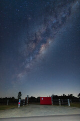 Fototapeta premium Milky way galaxy over the red gate door.