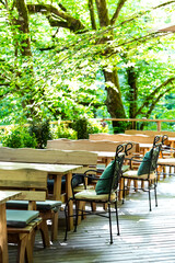 stylish wooden furniture in a summer outdoor cafe