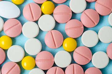 Many colorful pills macro.