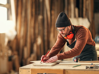 Joiner making marks on wooden detail - obrazy, fototapety, plakaty