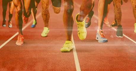 Composition of legs of running male athletes on racing track