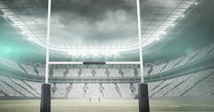 Composition of rugby goal and empty sports stadium with glowing spotlights