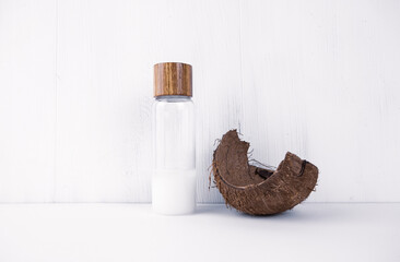 Fototapeta na wymiar Coconut oil in a coconut shell on a white background