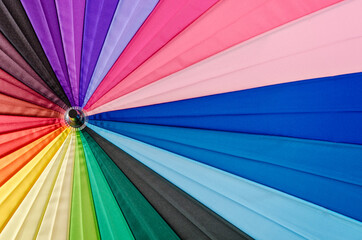 close up rainbow coloured umbrella textured.