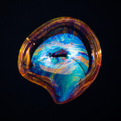 Amorphous and colorful isolated soap bubble with black background.