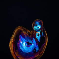 Amorphous and colorful isolated soap bubble with black background.