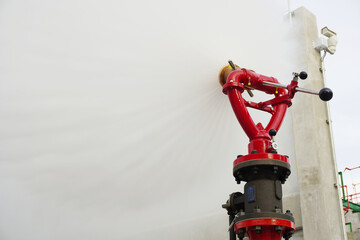 Water flowing vigorously from open fire hydrant as part of the fire extinguishing system testing...