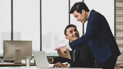 Male entrepreneurs using tablet in office