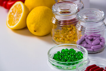 Fototapeta na wymiar Glassware with vitamins near lemons