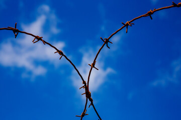 barbed wire on blue sky background