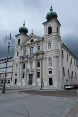 Gorizia, Italy - May 25, 2021: Piazza della Vittoria. Chiesa di Sant'Ignazio (Saint Ignazio church) with no people. Friuli Venezia Giulia. Cloudy spring afternoon day with dark clouds.