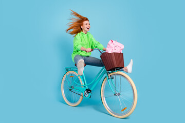 Photo of sweet funky young woman wear green sweatshirt driving cycle rucksack looking empty space...