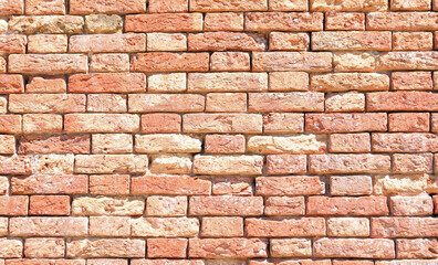 red old bricks of an ancient house made of terracotta