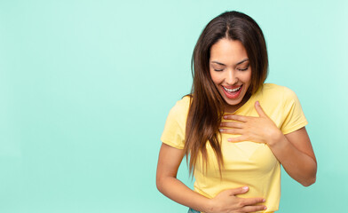 young hispanic woman laughing out loud at some hilarious joke