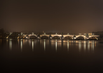 Night shot of Charles Bridge - Karluv most - over river Vltava in Prague; taken from Strelecky ostrov, long exposure