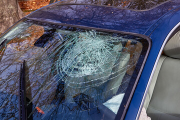 Damaged windshield of a car after accident on a road