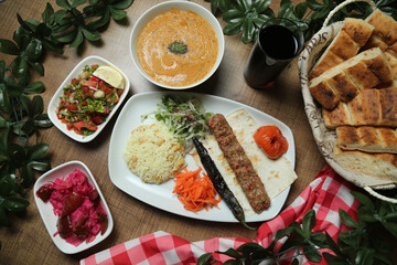 Turkish Adana Kebab with fresh vegetables on flatbread Top view, flat lay