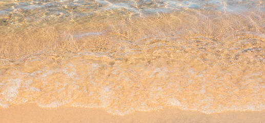 Soft sea wave on sand beach. Summer background. Concept of travel, vocation, relax