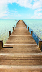 boardwalk to the horizon, tropic sea and light blue sky