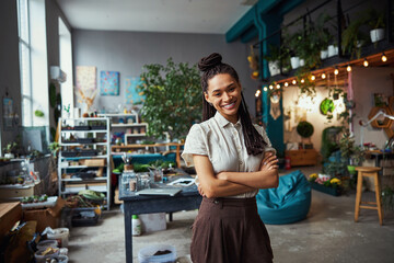 Pretty florist with cornrows looking in front of her