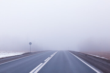 Fototapeta premium abstract winter road fog snow, landscape view in november transport