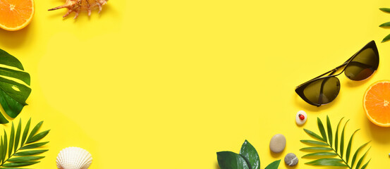 Summer background. Palm leaf, orange, starfish and seashell on yellow background. Travel.