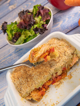 Salmon Parmentier recipe with hazelnuts, young salad leaves. High quality photo
