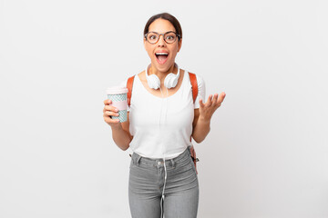 young hispanic woman amazed, shocked and astonished with an unbelievable surprise. student concept