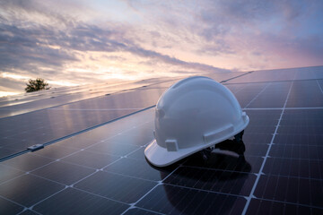 helmet of engineer working on checking equipment in solar power plant, photovoltaic modules for...