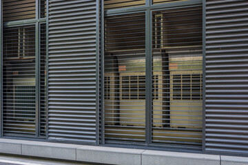Measure the outdoor unit of the air conditioner in the grille outside the building